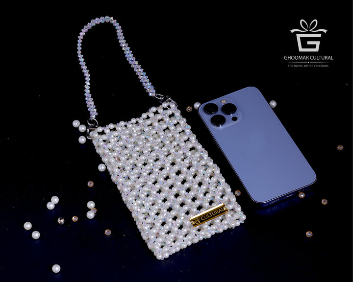 Add a touch of grace to your look with our White Crystal Pearl Mobile Pouch. Handcrafted with shimmering crystals and classic pearls, this elegant clutch fits all phone sizes and is perfect for weddings, festive events, or evening outings. A timeless accessory that blends beauty and function.